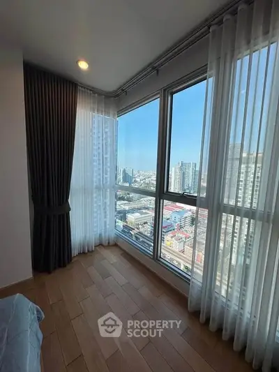 Bright corner unit with floor-to-ceiling windows offering stunning city views, perfect for urban living.