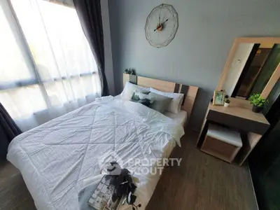 Cozy bedroom with modern decor and natural light, featuring a stylish bed and a chic vanity area.