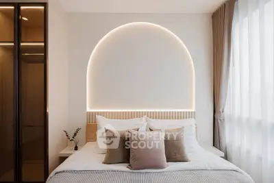 Elegant bedroom with modern lighting and cozy decor, featuring a stylish headboard and soft pillows.