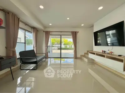 Spacious modern living room with large windows and sleek decor
