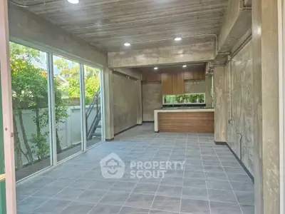 Spacious modern living room with open kitchen and large windows