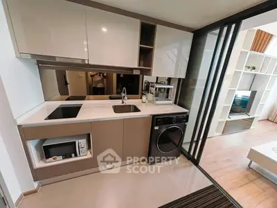 Modern kitchen with sleek appliances and open layout in stylish apartment
