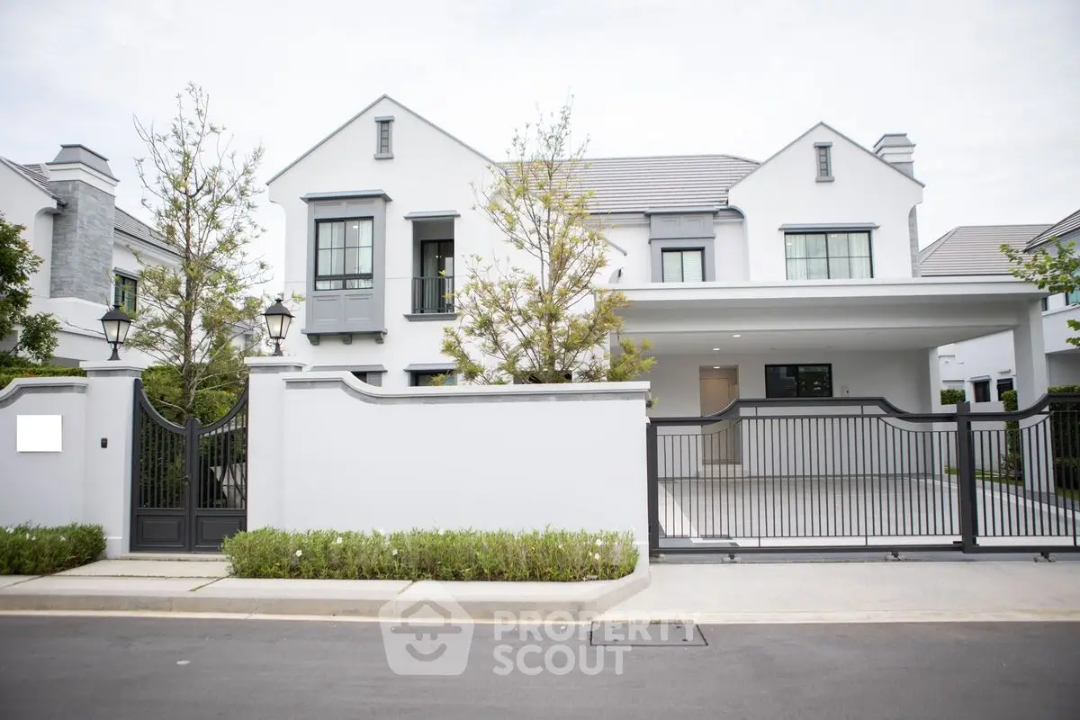 Elegant modern house with gated entrance and manicured landscaping