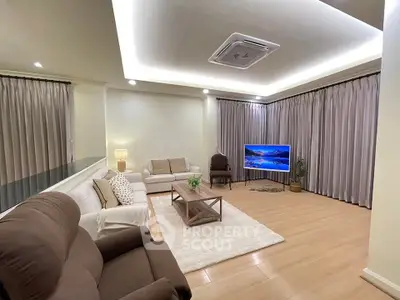 Spacious living room with modern furniture and ambient lighting, perfect for relaxation and entertainment.