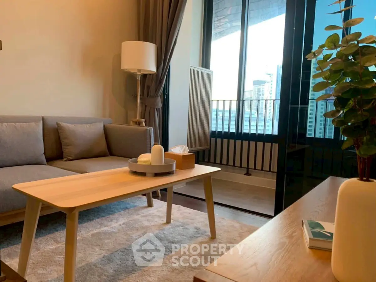 Modern living room with cozy sofa, stylish decor, and large window offering city view.