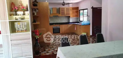 Spacious kitchen with wooden cabinets and dining area in modern home