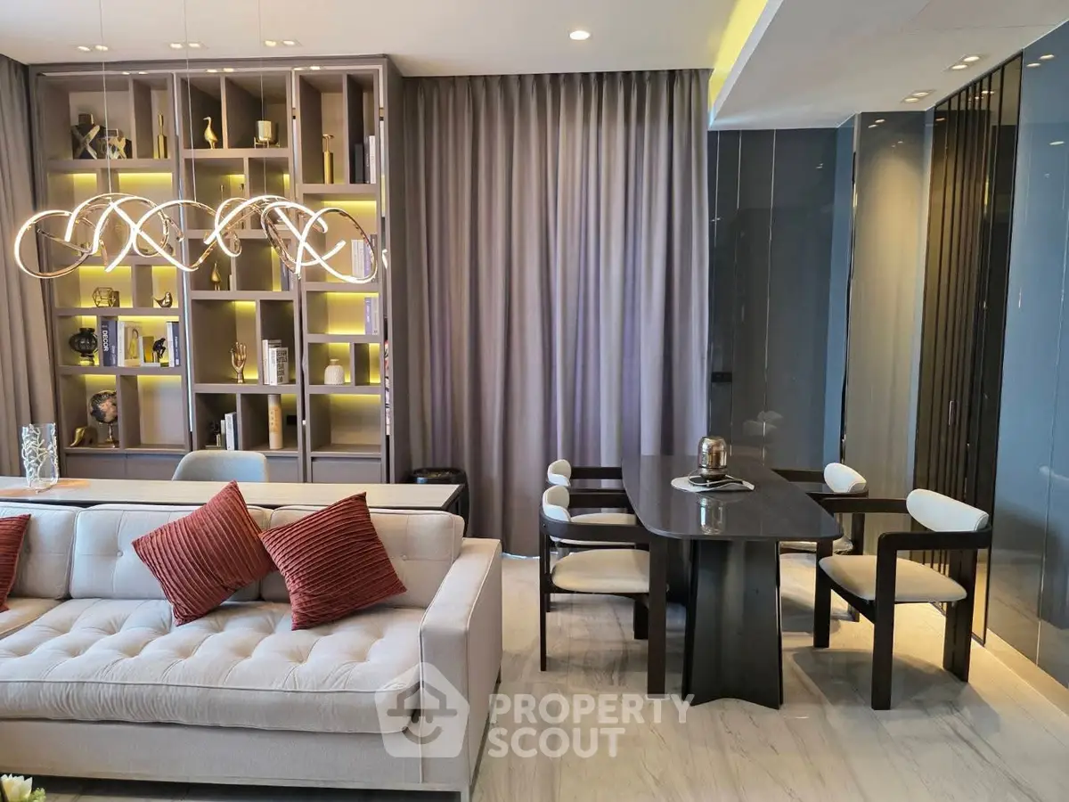 Luxurious living room with modern chandelier and elegant dining area