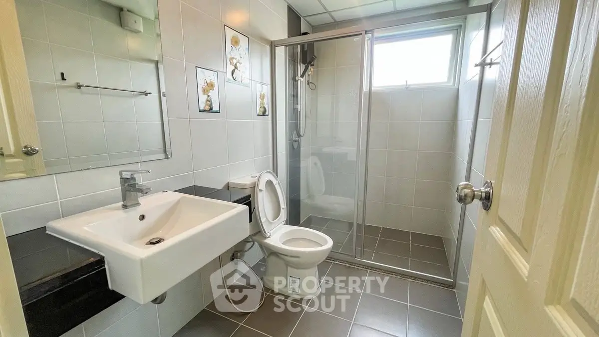 Modern bathroom with sleek fixtures and glass shower enclosure