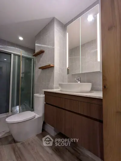 Modern bathroom with sleek fixtures and elegant wood accents