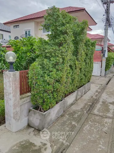 Charming suburban house with lush green hedges and modern design