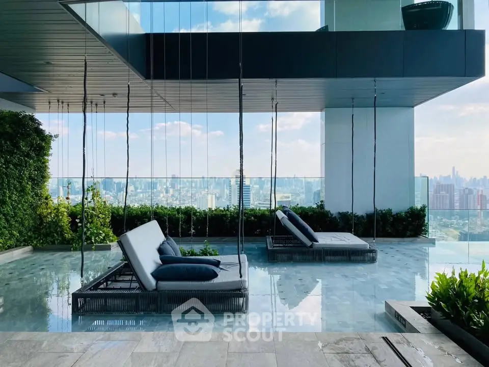 Luxurious rooftop pool with stunning city skyline view and modern lounge chairs.