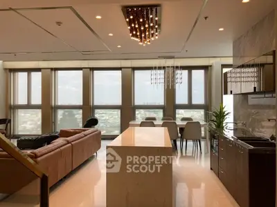Luxurious open-plan living room with stunning city views and modern kitchen island.