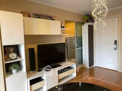 Modern living room with stylish white furniture and elegant chandelier, perfect for cozy family gatherings.
