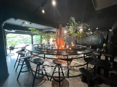 Unique interior with central tree feature and modern seating in stylish lounge area.