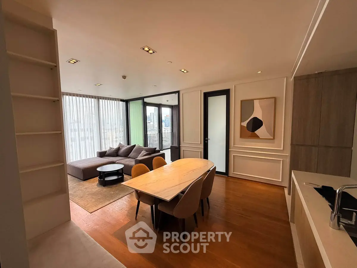 Modern open-plan living and dining area with stylish decor and city view.