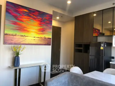 Modern living room with vibrant artwork, sleek furniture, and stylish decor in a contemporary apartment.