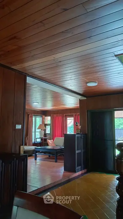 Charming wooden interior living room with cozy seating and natural light