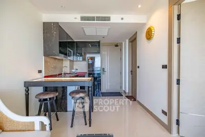 Modern kitchen with open layout and stylish bar stools in a contemporary apartment.
