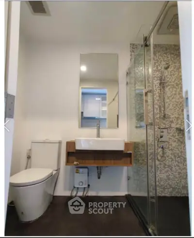 Modern bathroom with sleek fixtures and glass shower enclosure
