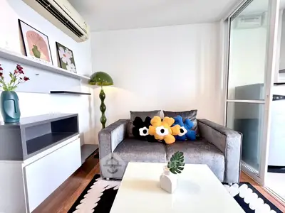 Chic modern living room with stylish decor and cozy sofa in a bright apartment.