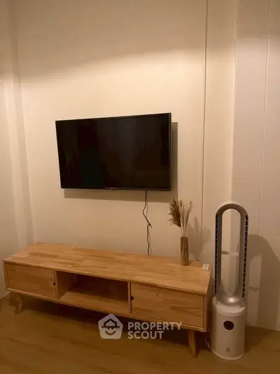 Modern living room with wall-mounted TV and stylish wooden console