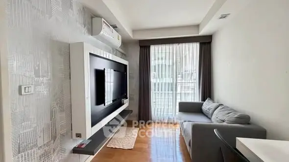 Modern living room with sleek TV setup and cozy sofa in bright apartment