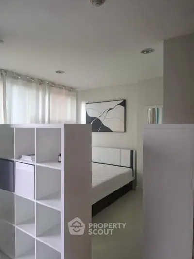 Modern bedroom with minimalist design and partition shelving