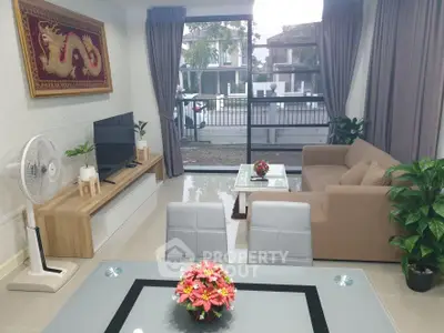 Modern living room with large window, stylish furniture, and elegant decor.