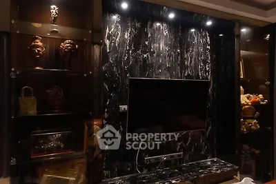 Luxurious living room with elegant marble TV wall and ambient lighting