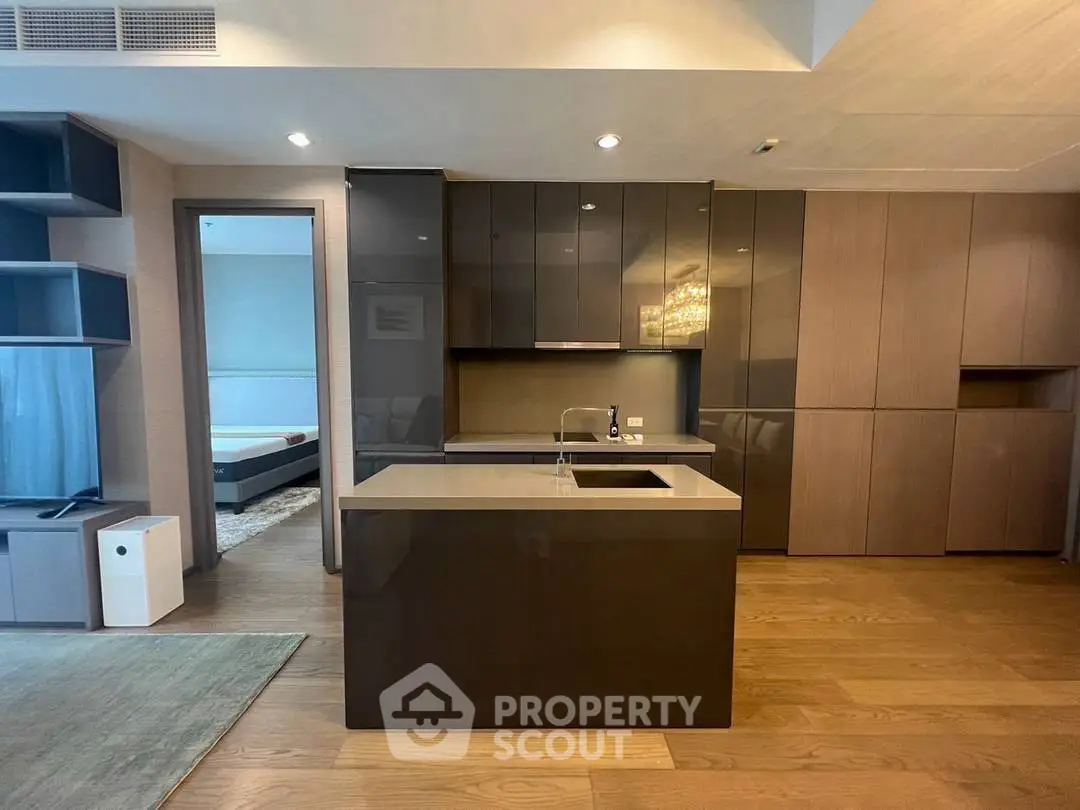 Modern kitchen with sleek cabinetry and island in luxury apartment