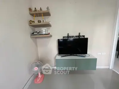 Modern living room with wall-mounted TV and decorative shelves