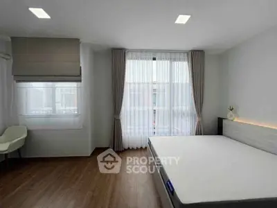 Spacious bedroom with large windows and modern decor