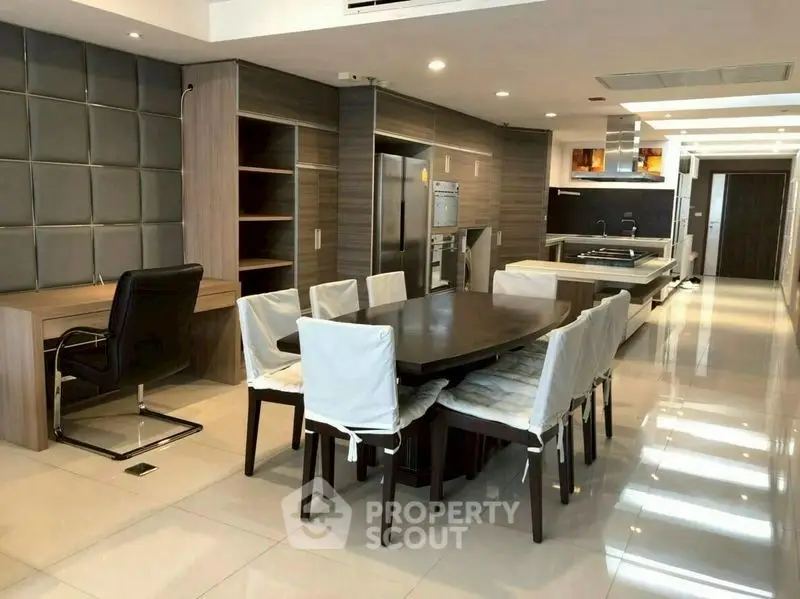 Luxurious open-plan kitchen and dining area with modern appliances and sleek design.
