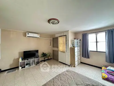 Spacious bedroom with natural light and modern amenities for comfortable living.