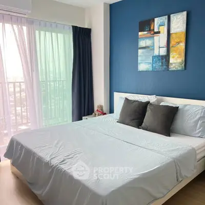 Modern bedroom with stylish decor and balcony view in a high-rise apartment.