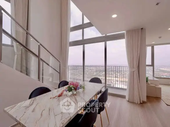 Luxurious high-rise apartment with stunning floor-to-ceiling windows and elegant dining area.