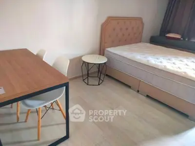 Cozy bedroom with modern furniture and natural light, perfect for relaxation.