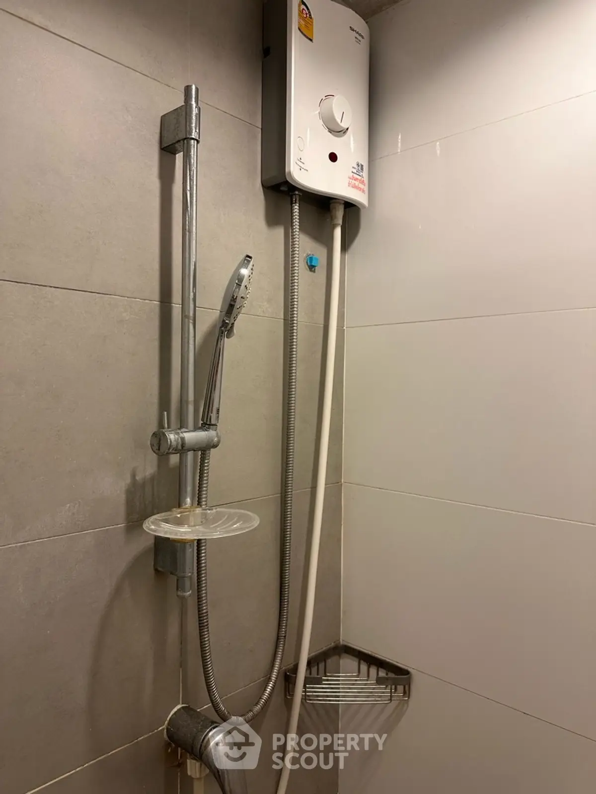 Modern bathroom with sleek shower and water heater, perfect for comfort and convenience.