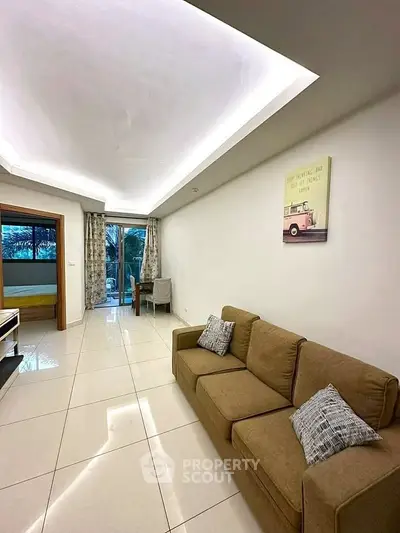 Spacious living room with modern decor and large windows offering natural light.