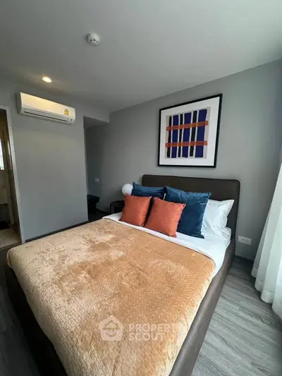 Cozy bedroom with modern decor and plush bedding in a stylish apartment.