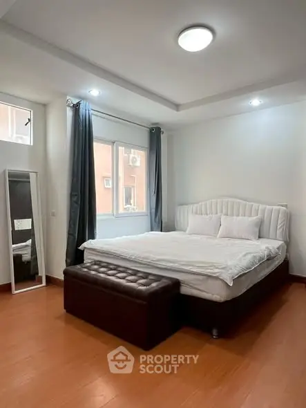 Spacious bedroom with elegant bed and natural light