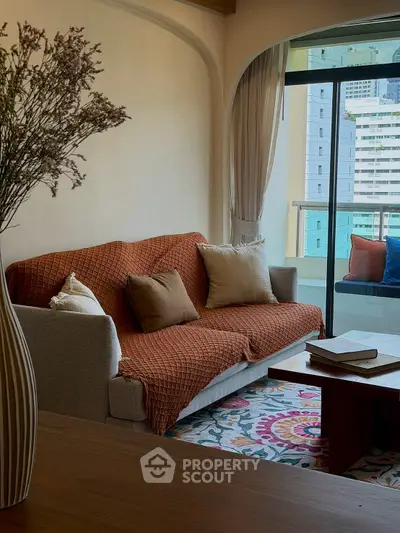 Cozy living room with stylish decor and balcony view in modern apartment