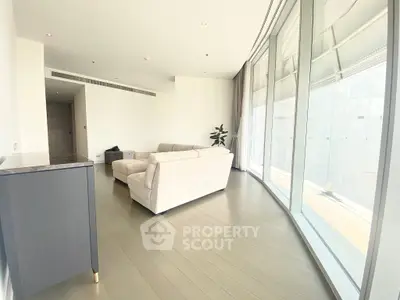 Spacious modern living room with large windows and elegant furniture