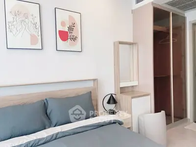 Modern bedroom with stylish decor and cozy ambiance, featuring elegant artwork and sleek furniture.