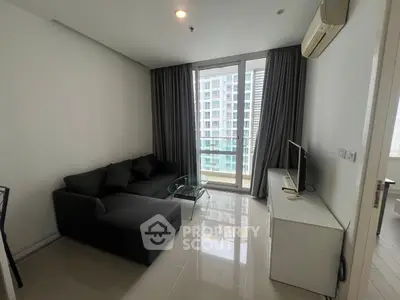 Modern living room with sleek furniture and city view balcony in high-rise apartment.