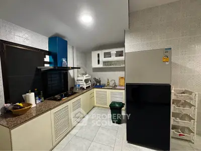 Modern kitchen with sleek appliances and ample storage space