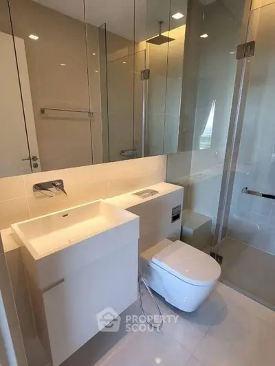 Modern bathroom with sleek fixtures and glass shower enclosure