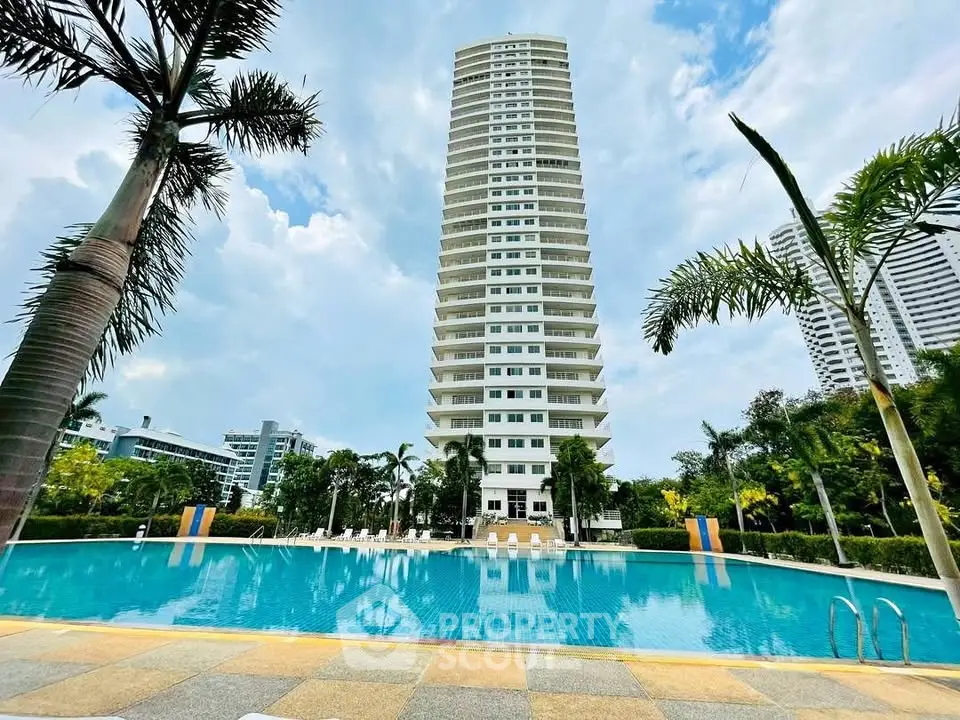Luxurious high-rise building with stunning pool and lush greenery