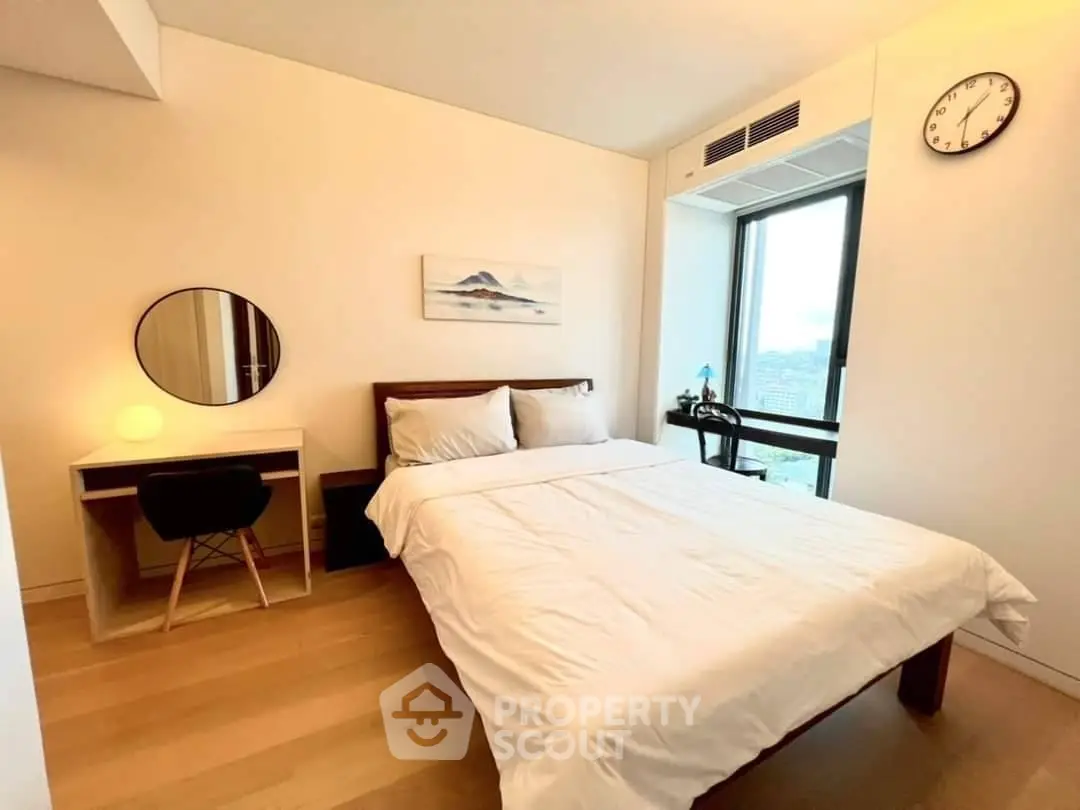 Modern bedroom with study desk and large window offering city view