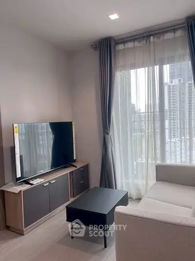 Modern living room with large TV and city view, perfect for urban living.